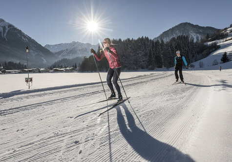 Zwei Langläufer auf einer verschneiten Strecke
