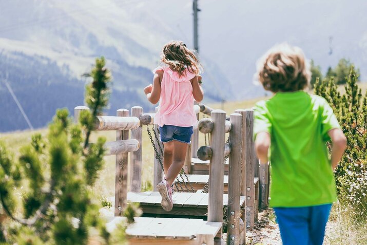 Ein Junge und ein Mädchen spielen auf einem Spielplatz