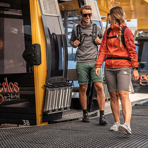 Ein Mann und eine Frau steigen aus einer Gondel aus