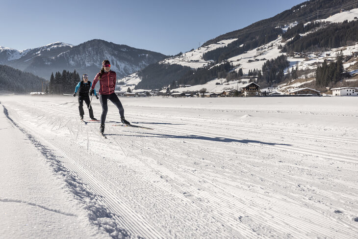 Zwei Langläufer auf einer verschneiten Strecke