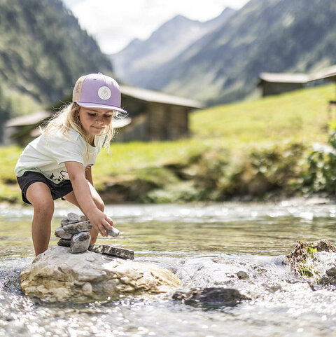 Ein kleines Mädchen spielt im Wasser